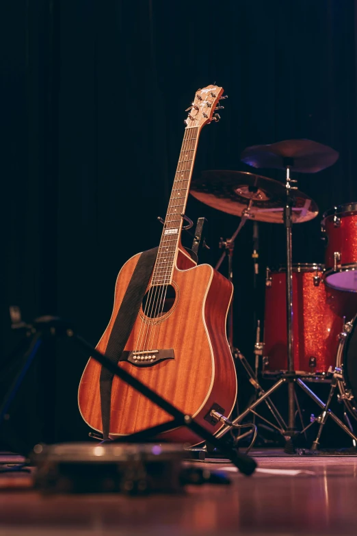 guitars and drums sitting in a studio setting