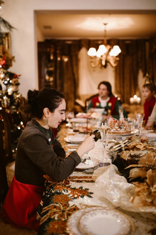 woman with red apron putting food onto a table