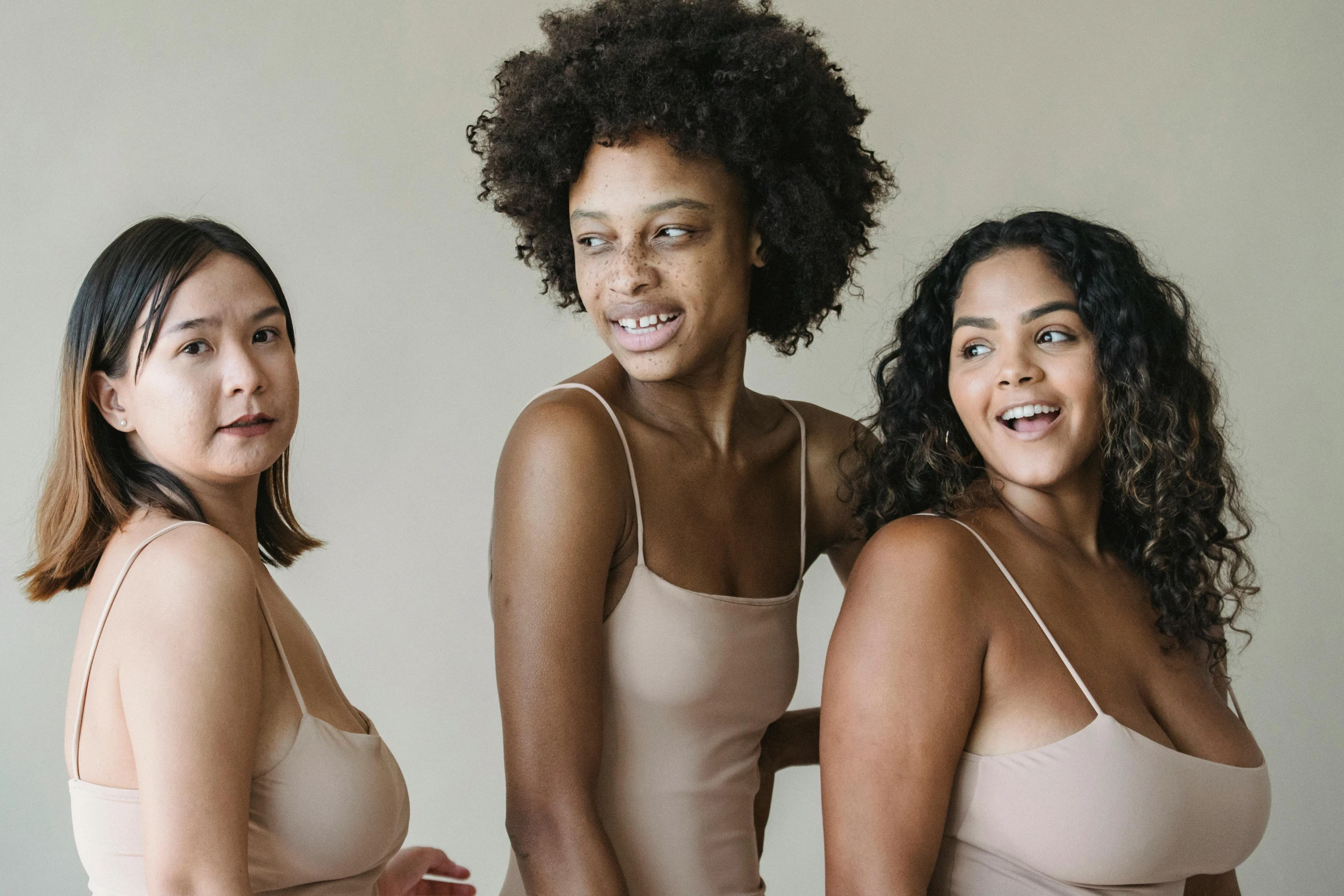 three women are looking at the camera