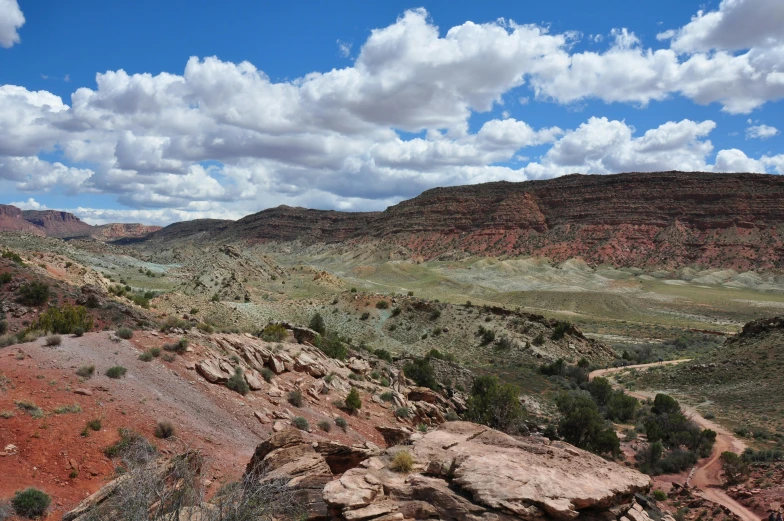 an arid valley surrounded by red and white rocky walls