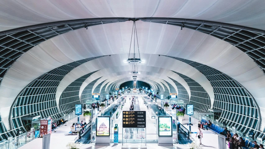 a large airport terminal has multiple escalators