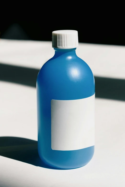 a bottle with a blank label on a white surface