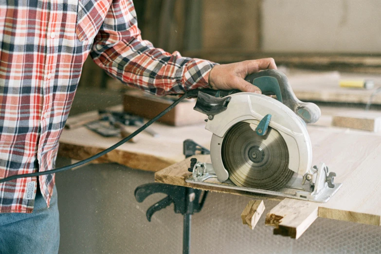 person using a circular device to cut and use a  machine