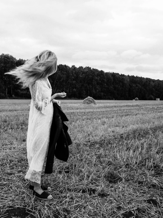 a girl with long hair walking away from the camera