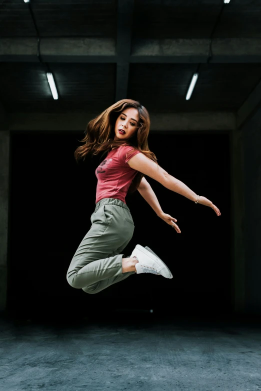 the young woman is jumping in the air on her skateboard