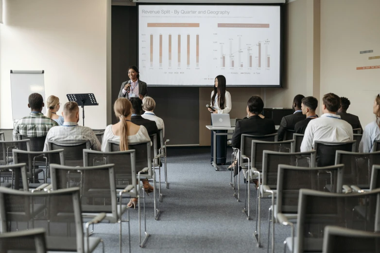 a group of people are sitting in front of an audience