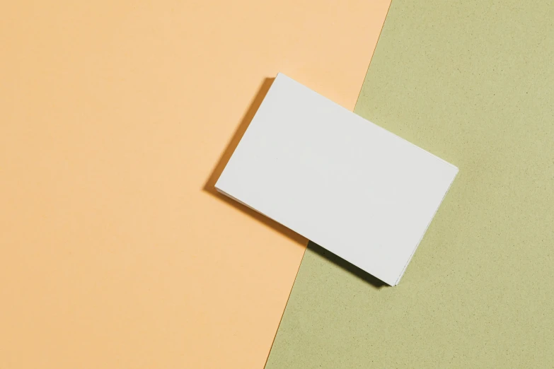 small white object on color paper on an orange background