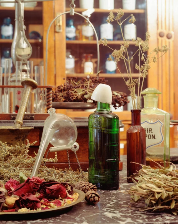 the table has all kinds of herbs in bottles and glass jars