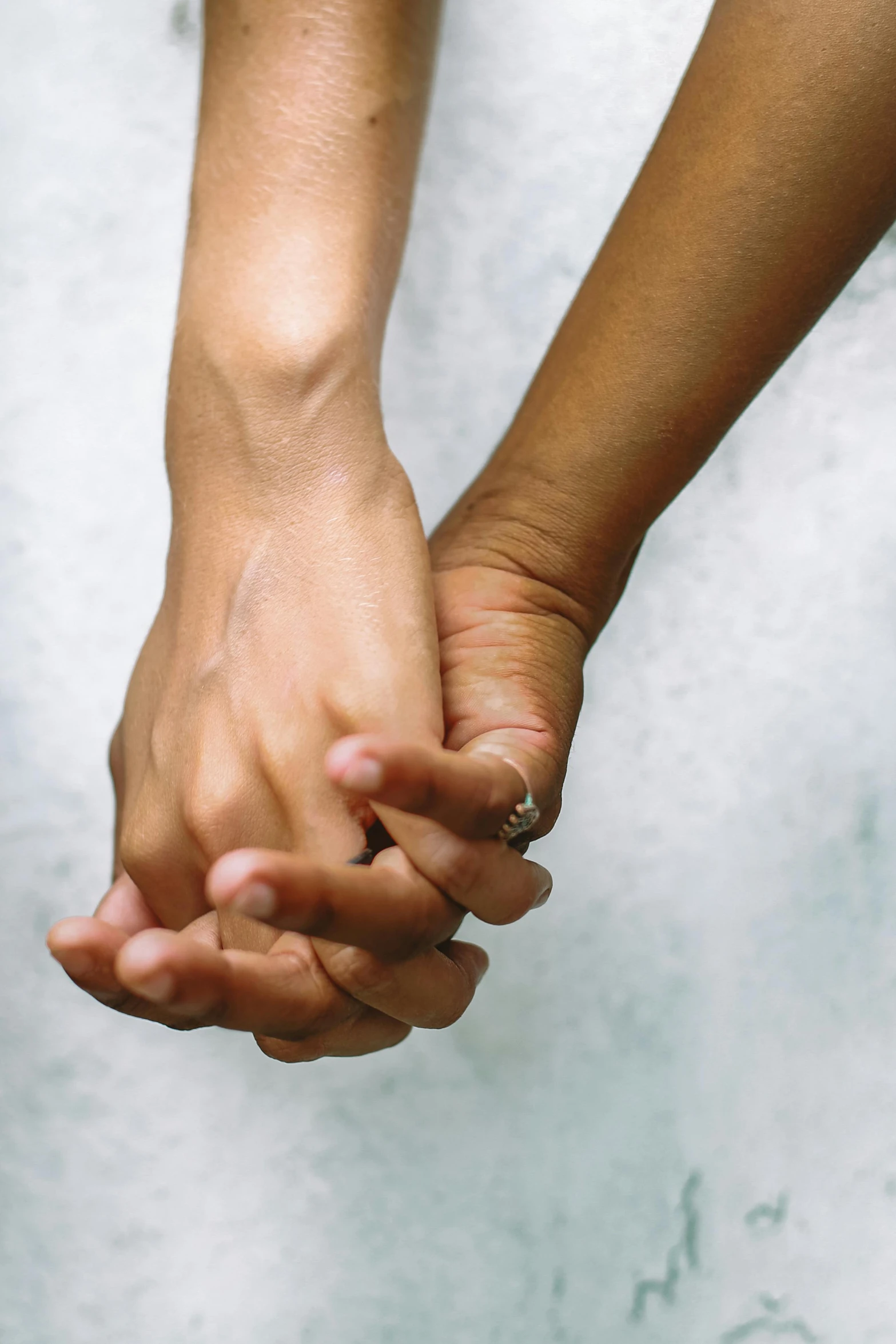 two people holding hands in their left palm
