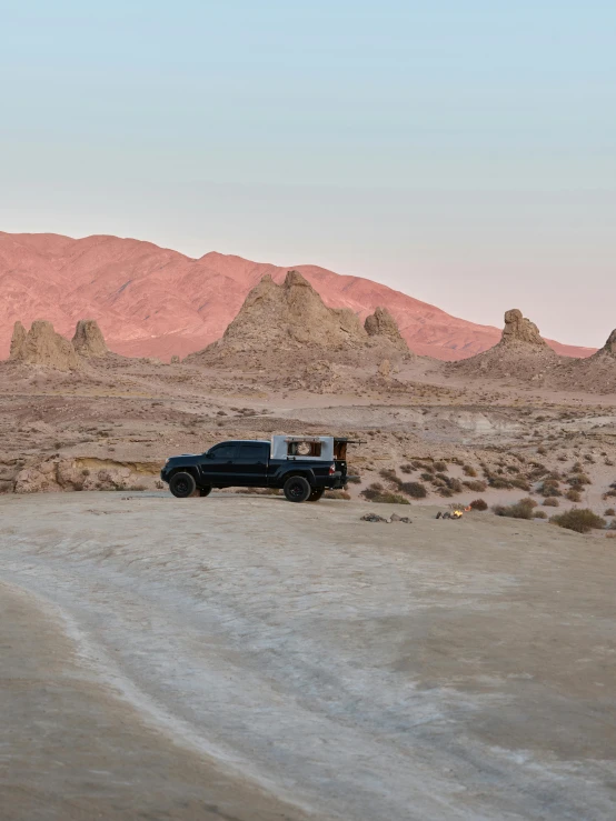 a truck parked in the middle of a desert