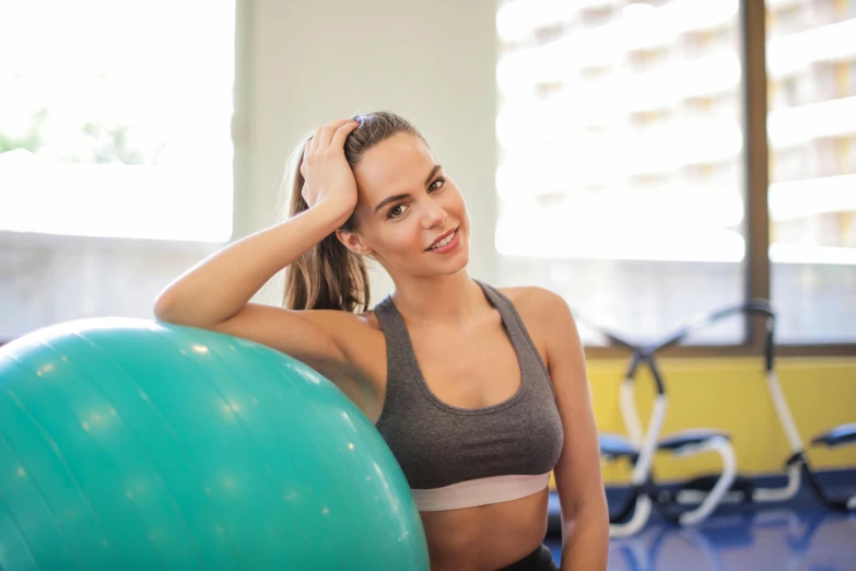 a woman smiles while working out in her gym