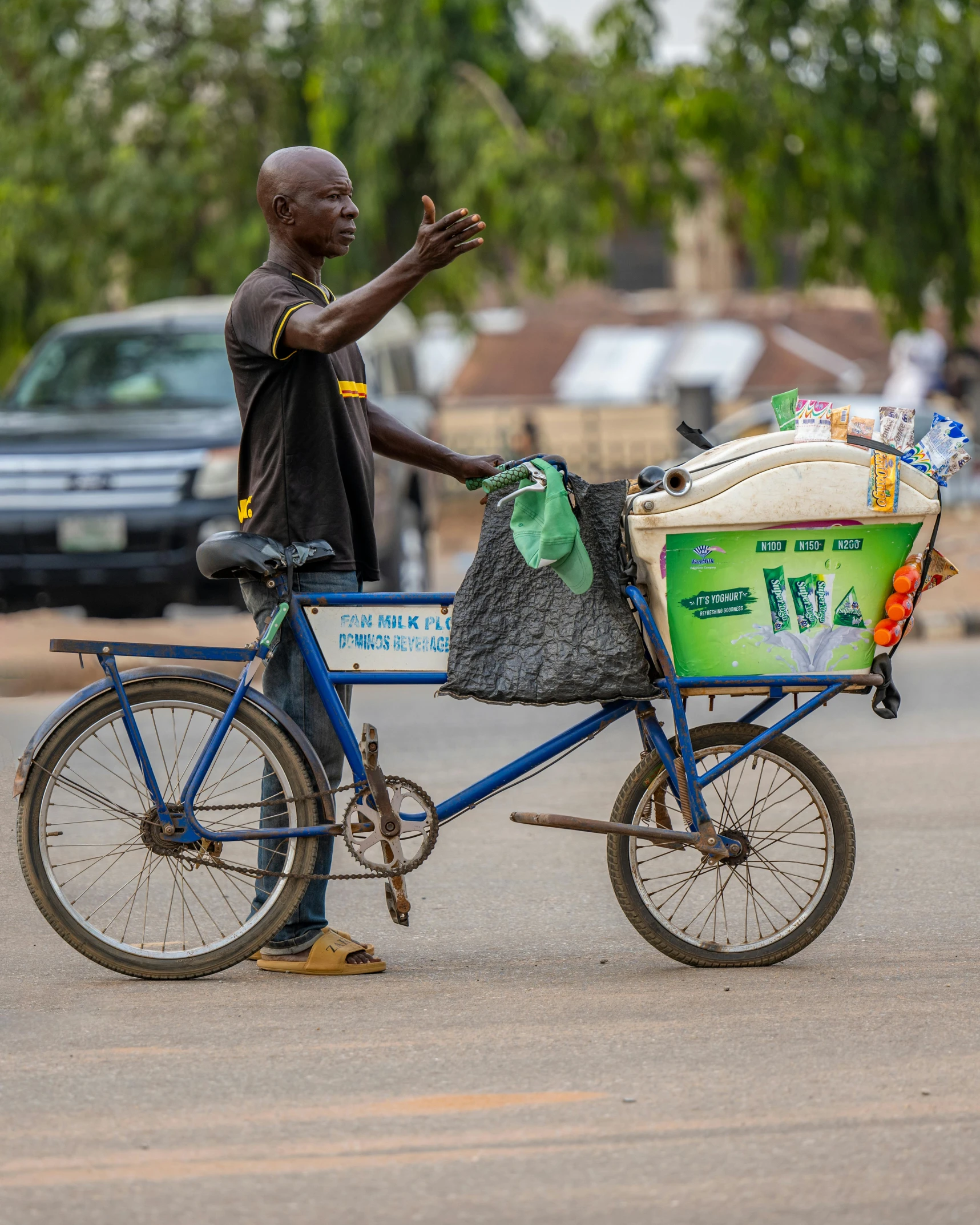 a man riding a bike on the road with luggage in it