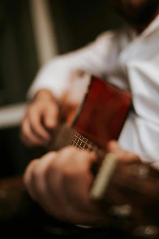 a person holding a piece of wood next to a window