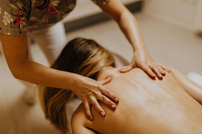 the woman in the back receiving massage on her back