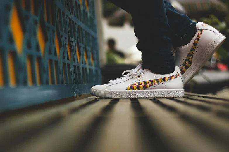 a person in sneakers stands on top of a wall