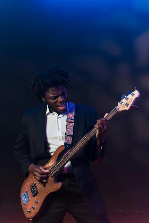 a man in a suit and tie playing a bass