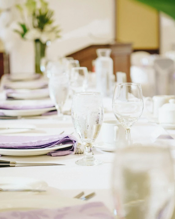 a table topped with empty glasses and white dishes