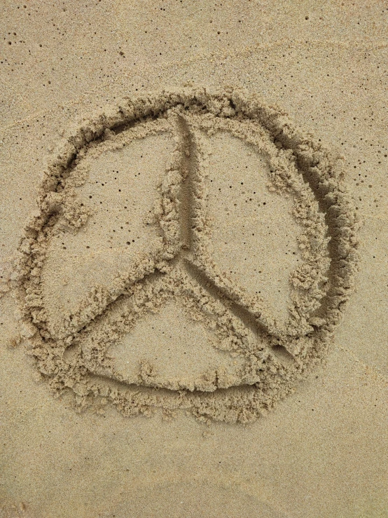 there is a peace sign drawn in the sand