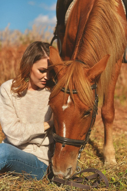 a woman petting a horse on the head