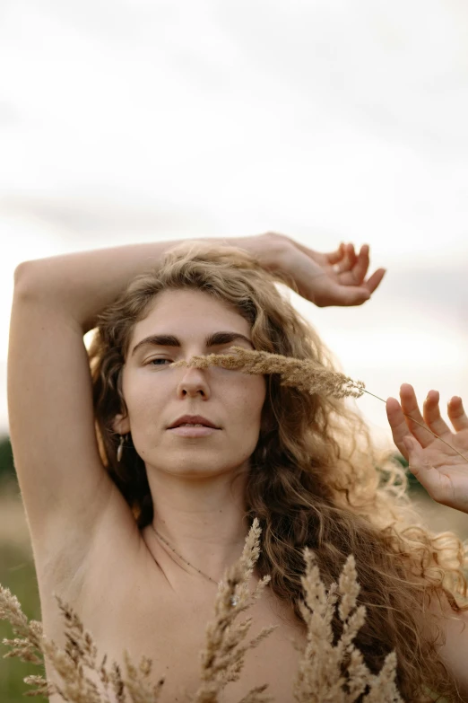 the young woman has her hands raised and is posing for a po