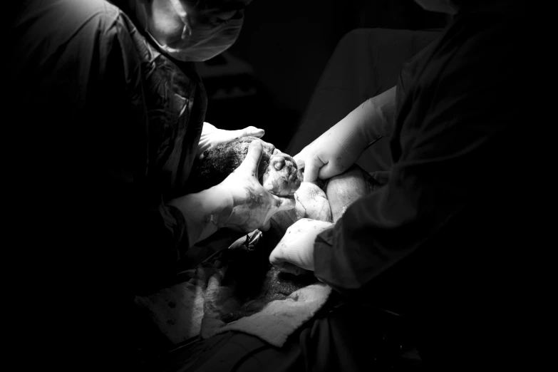 a person having their hair cut by someone in black and white