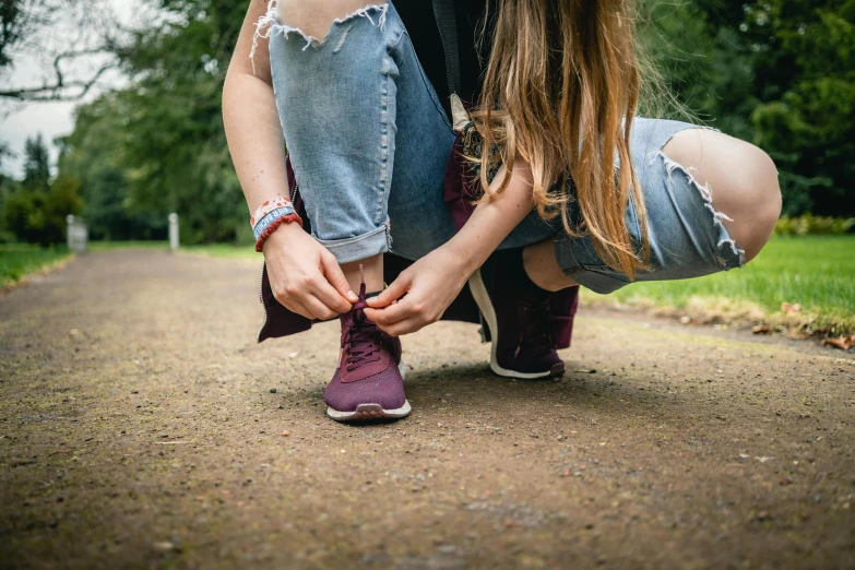 a couple of women are bending down to look at soing