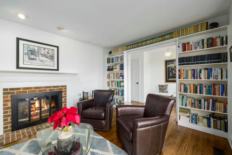 a living room with a fire place and book shelves filled with books