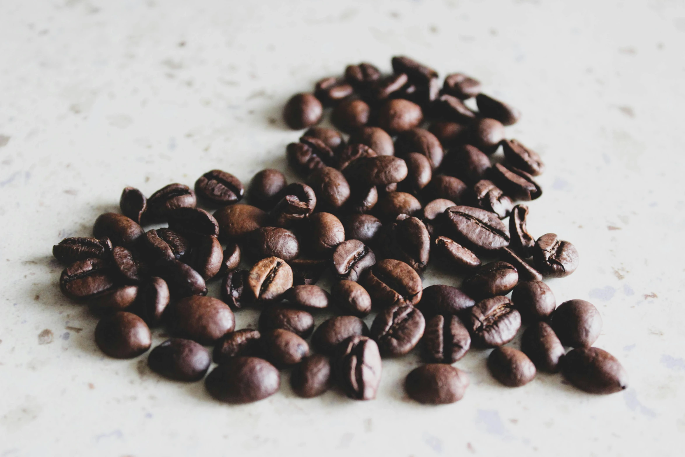 a table topped with coffee beans and beans of coffee