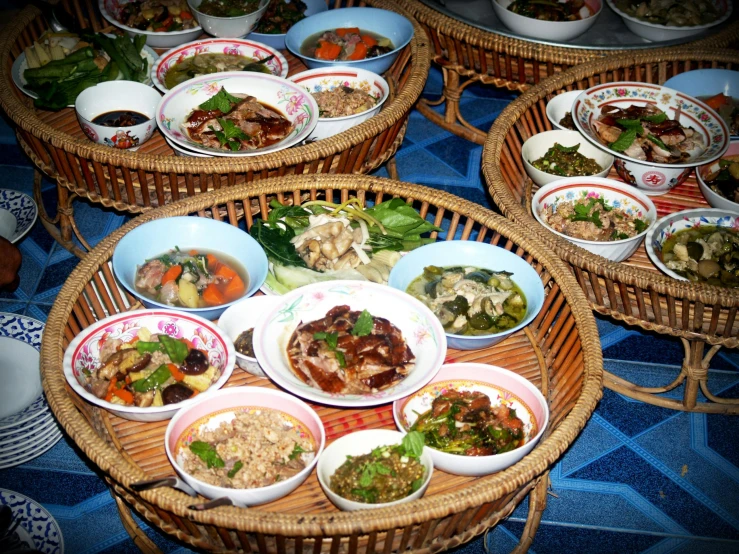 several bowls of food sitting on trays