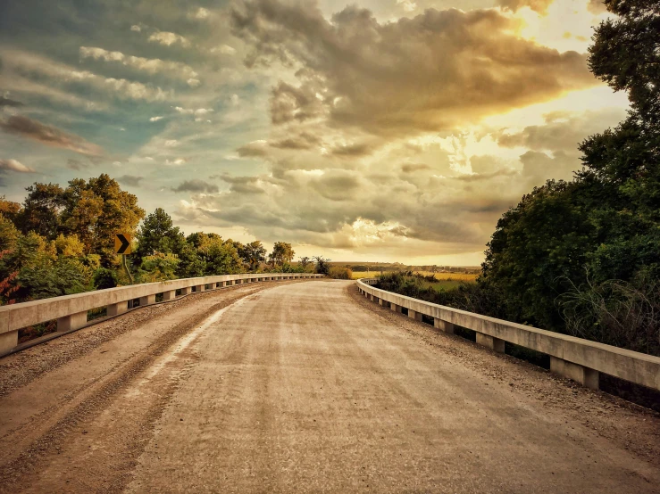 a long road is being blocked off with a bridge