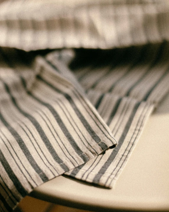a close up image of striped shirt in dark blue
