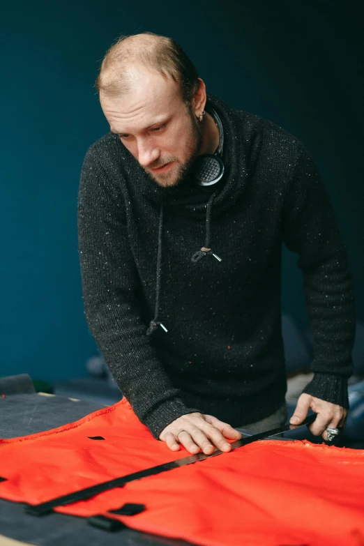 a man  out fabric on a table