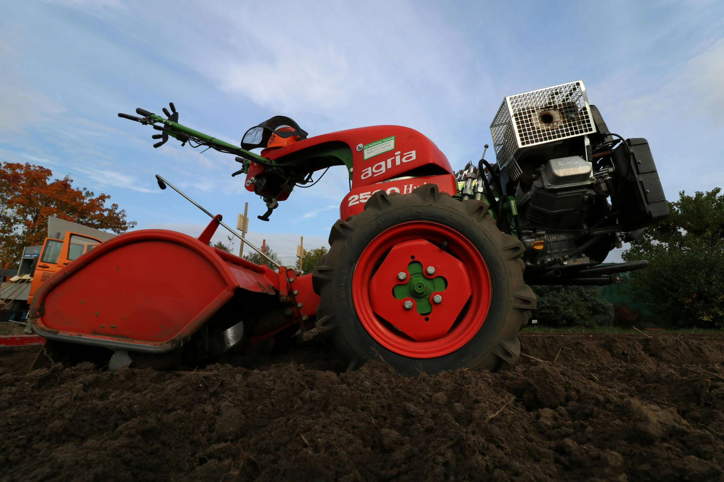 a farmallist operating a tractor with two plows attached to the back of it