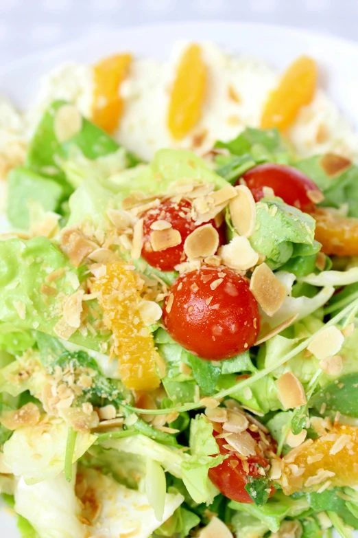 a salad with fresh fruit, nuts and dressing