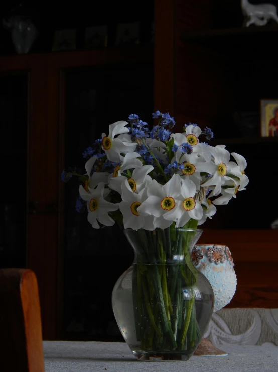 the flowers are in a clear vase on the table