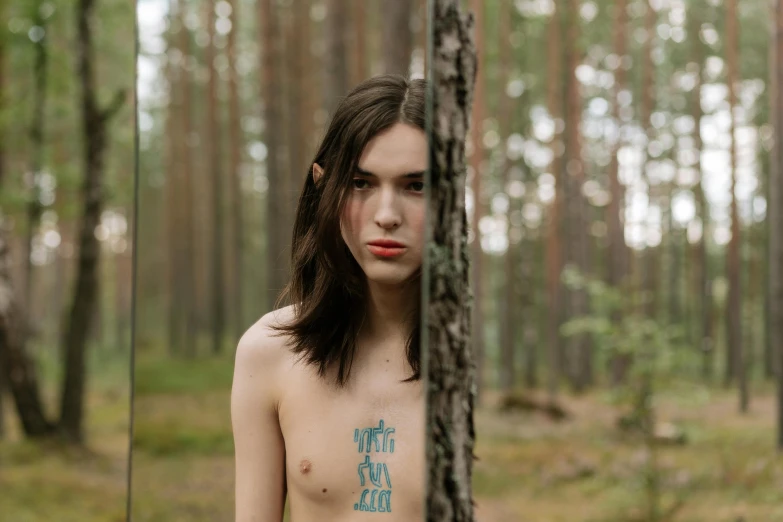 a  woman is standing in a forest