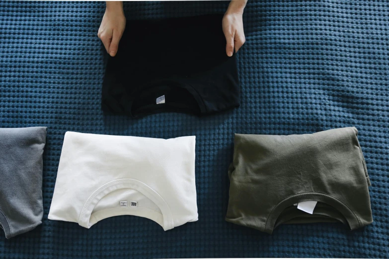 various types of underwear sit on a bed