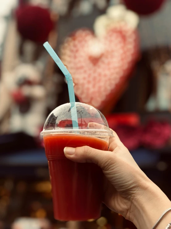 the woman's hand is holding a drink in front of her