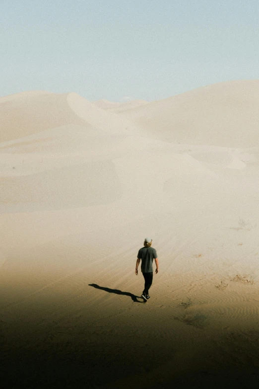 the man is walking alone in the open field