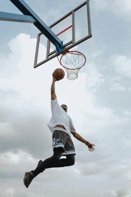 a man dunking a basketball in the air