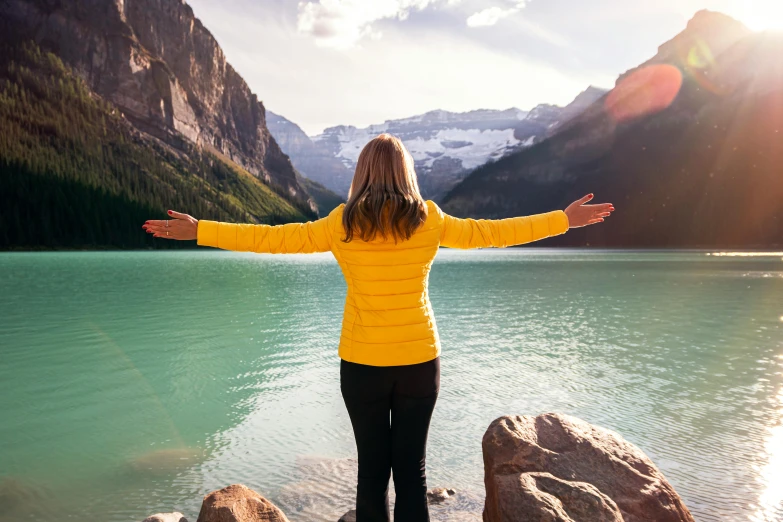 a woman that is standing near the water