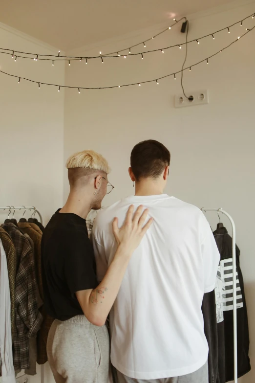 a woman standing next to a man wearing a white shirt