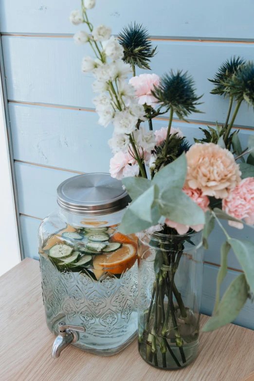 vases of flowers sit near one another on a wooden surface