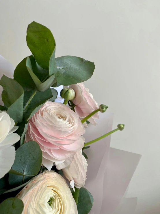 a bouquet of flowers and greens are laying on the floor