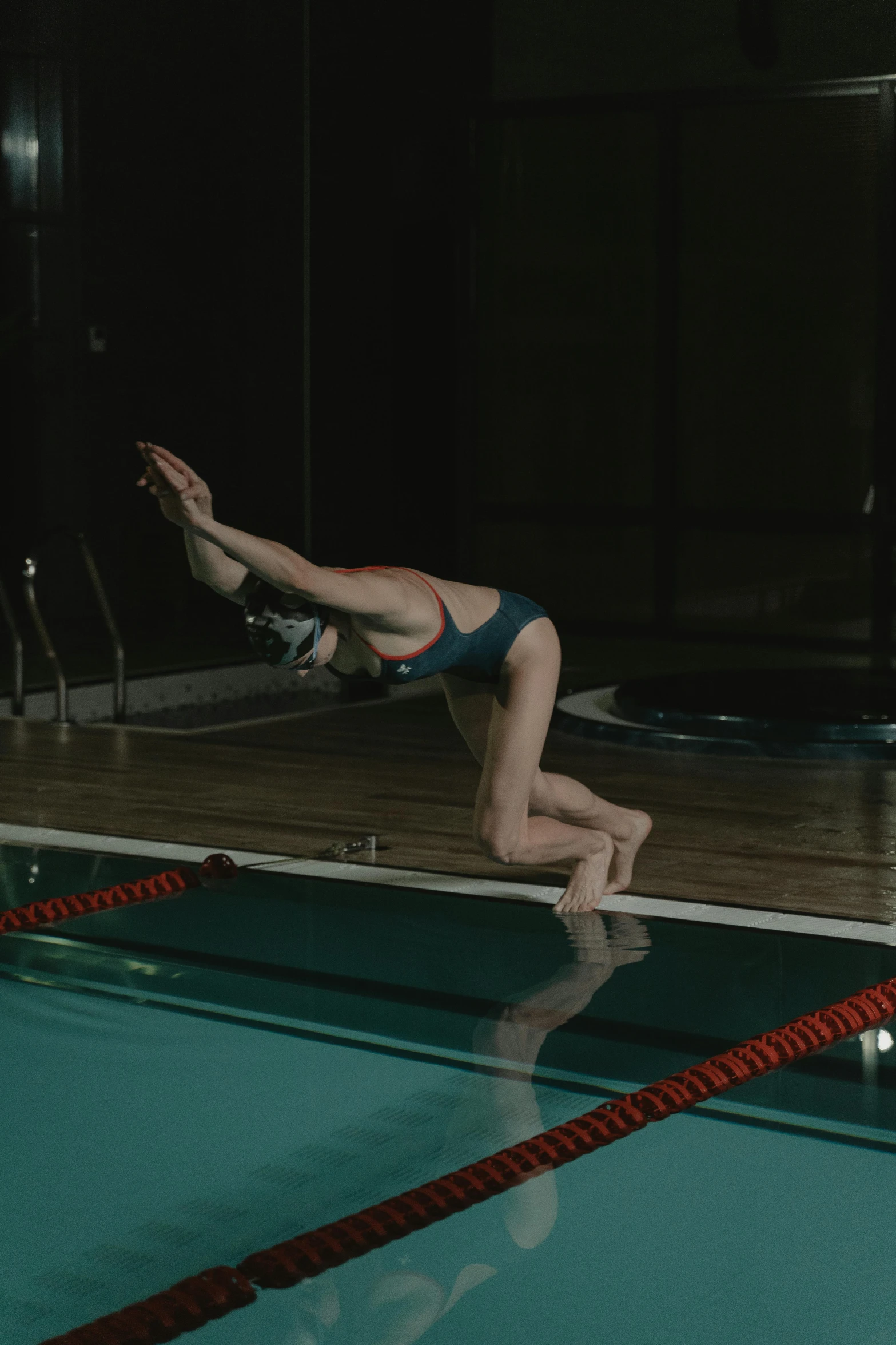 a woman diving from her swimming board onto the water