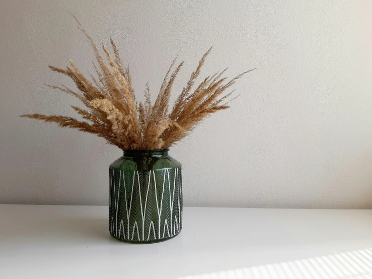 a vase with some flowers sitting on top of a table