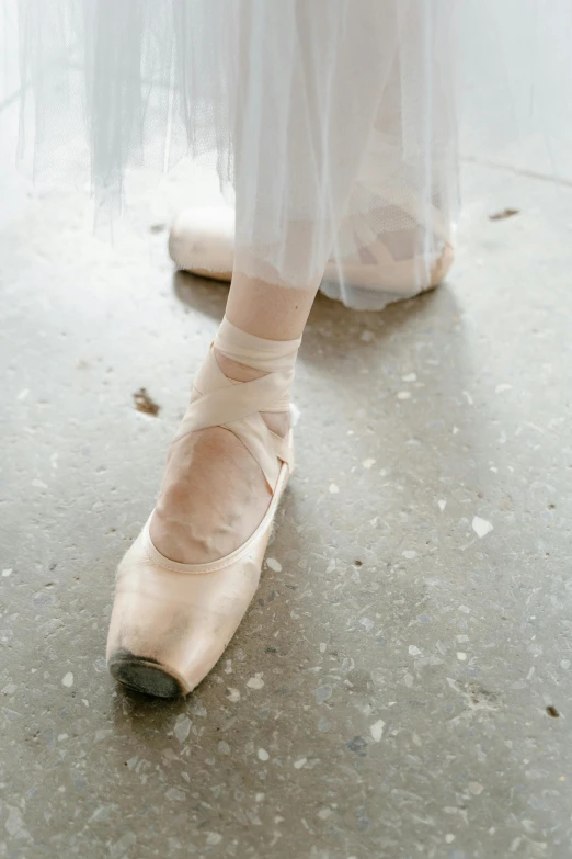 woman in a white dress and ballet shoes