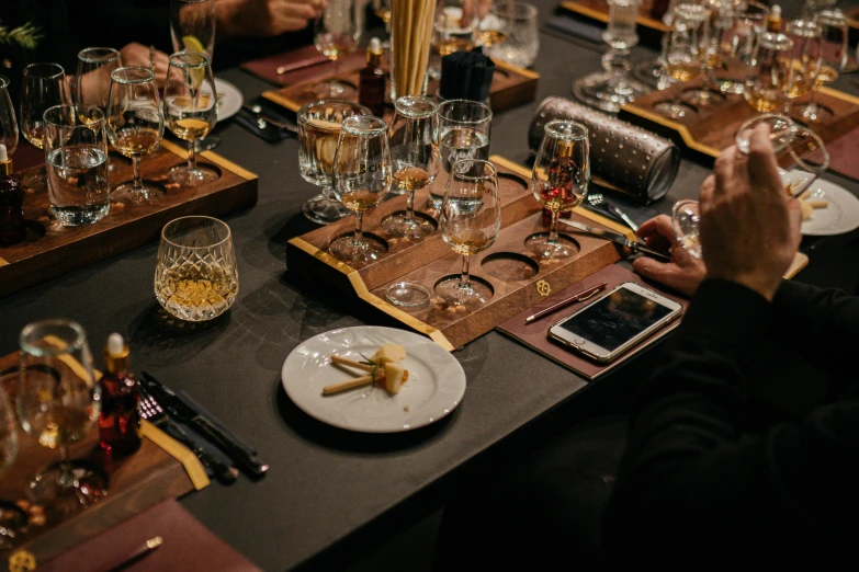 people holding their hands over the dinner tables set for a meal