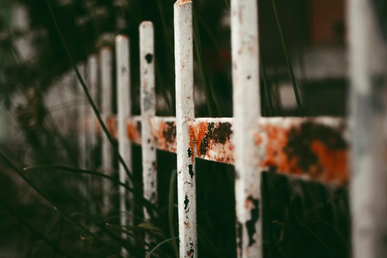 rusted metal and wood divider with a rusted red cross on the side