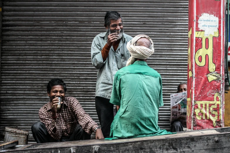 two men stand with their heads wrapped over